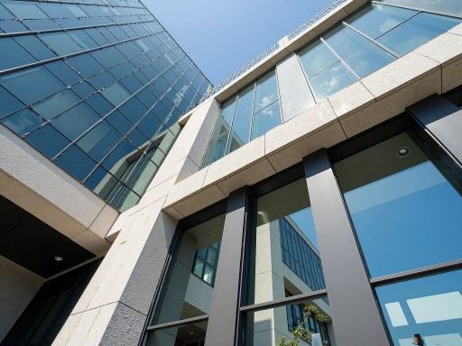 公司办公楼外观，现代化工业建筑风格，门前绿化带整洁美观，展现企业的良好形象